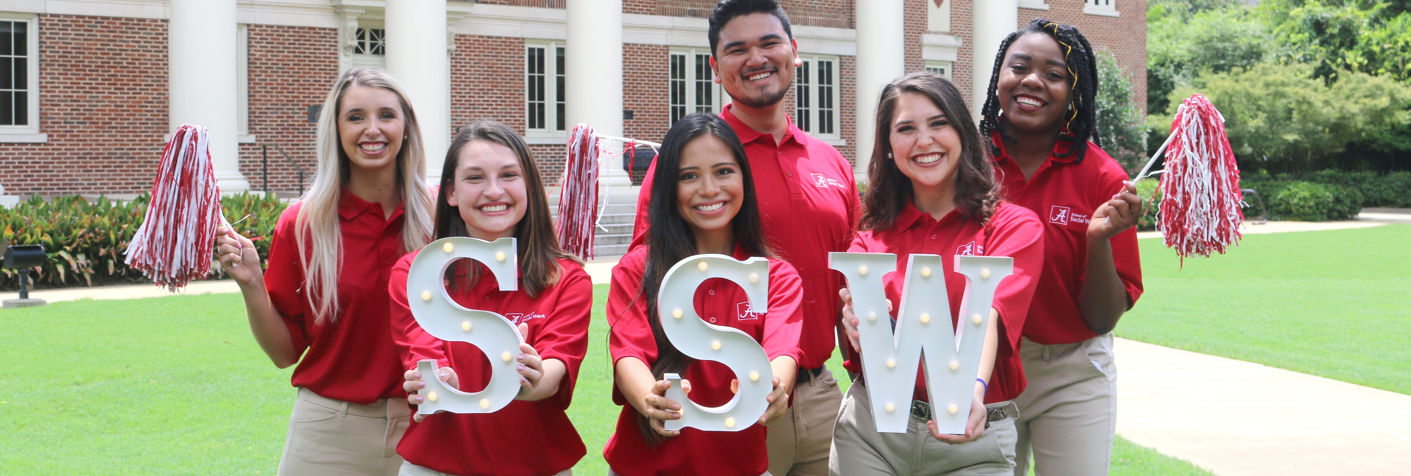 Several university students pose for a photo outdoors