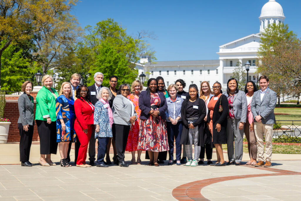 Photo of School of Social Work Board of Friends and Social Work Society in front of UA Welcome Center.