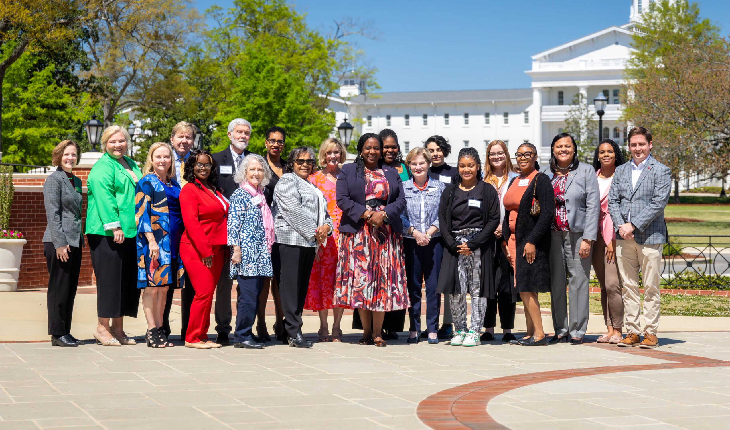 Photo of School of Social Work Board of Friends and Social Work Society in front of UA Welcome Center.