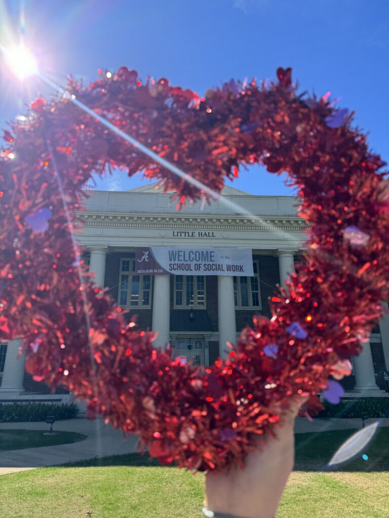 Valentine's heart surrounding "Welcome to Little Hall" banner on front of Little Hall.