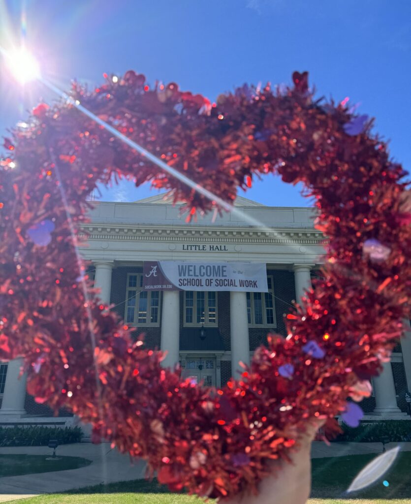 Valentine's heart surrounding "Welcome to Little Hall" banner on front of Little Hall.