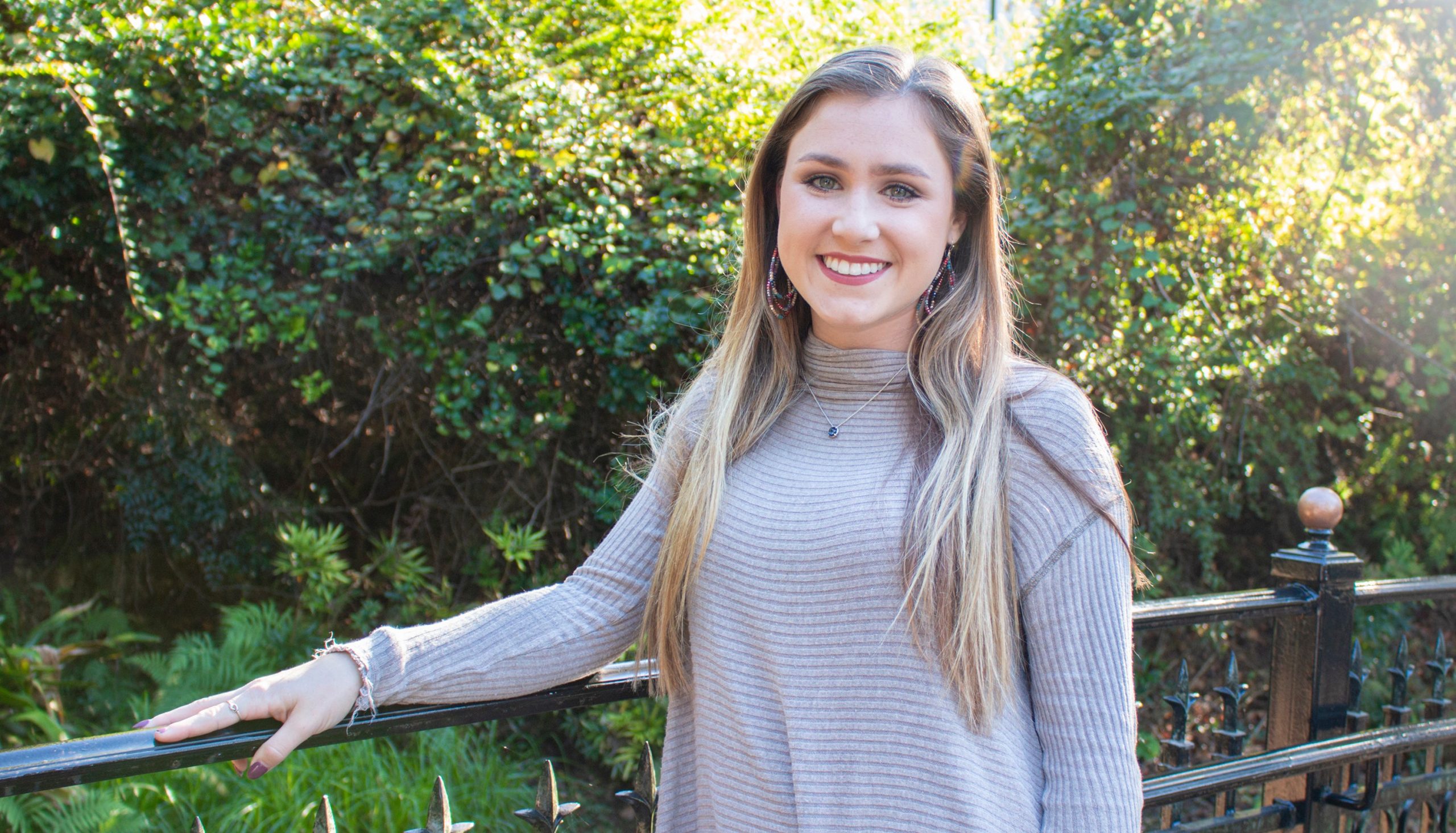 A white female student poses for a photo outdoors