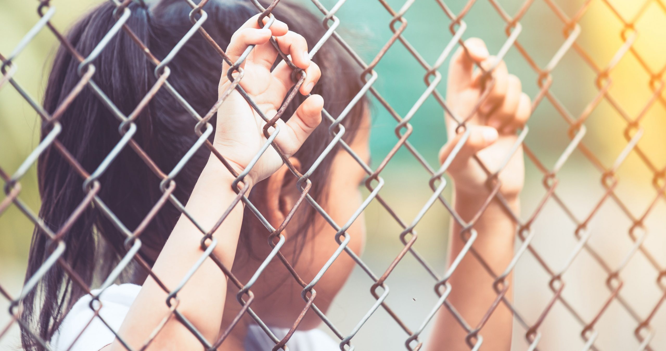 Child little girl hand holding steel mesh in vintage color tone