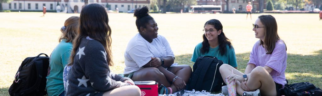 a group of students talking on the quad