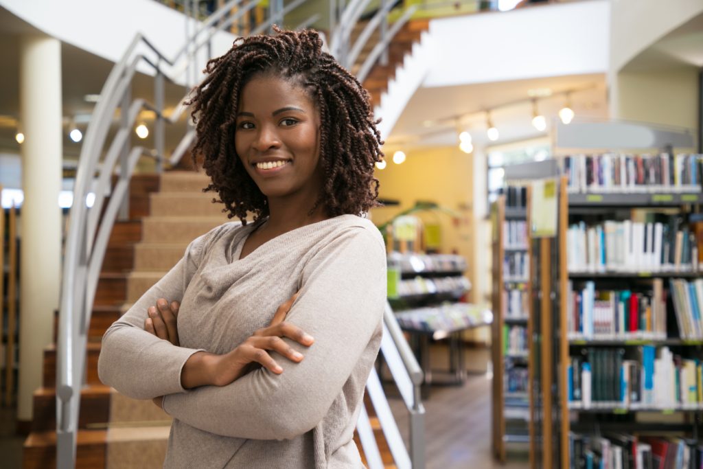 Cheerful smiling woman posing at public library