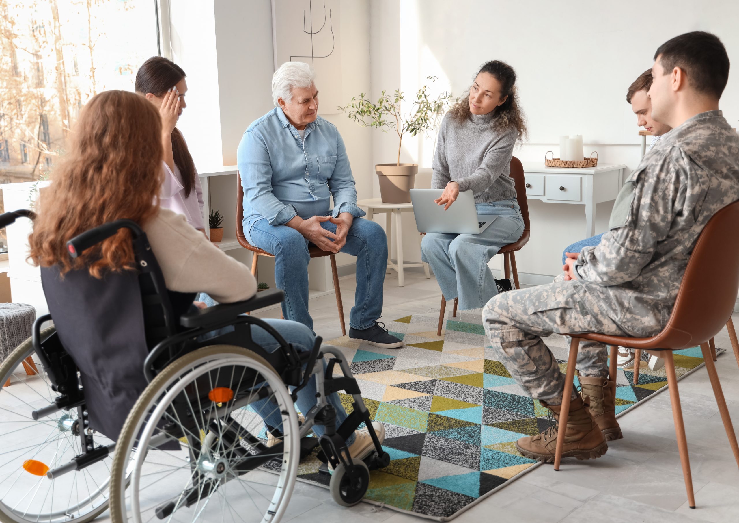 Female psychologist talking at group therapy session