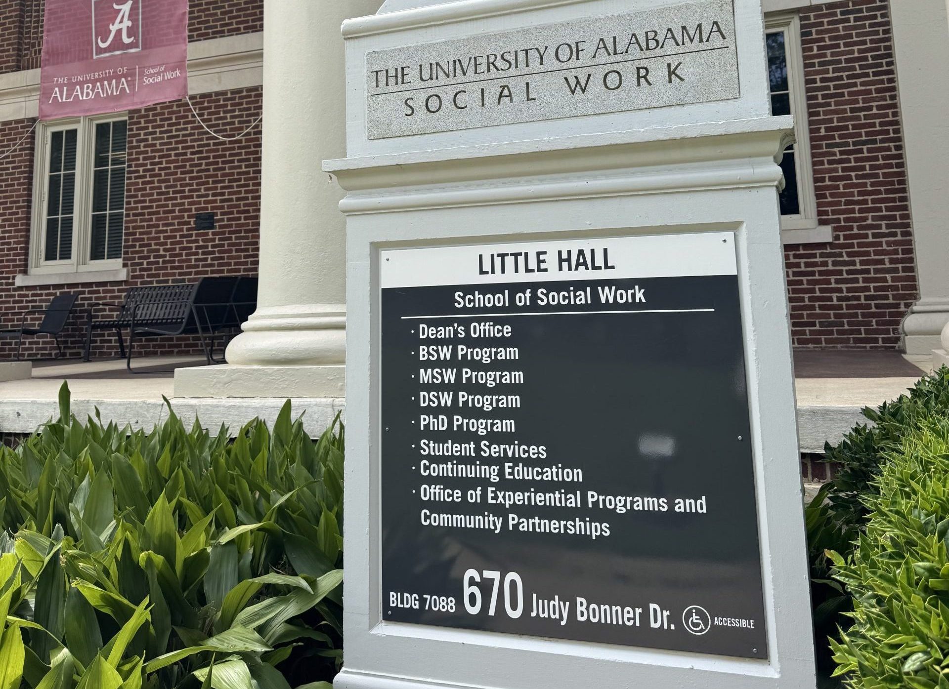 Sign outside The University of Alabama School of Social Work at Little Hall, listing academic programs and services.
